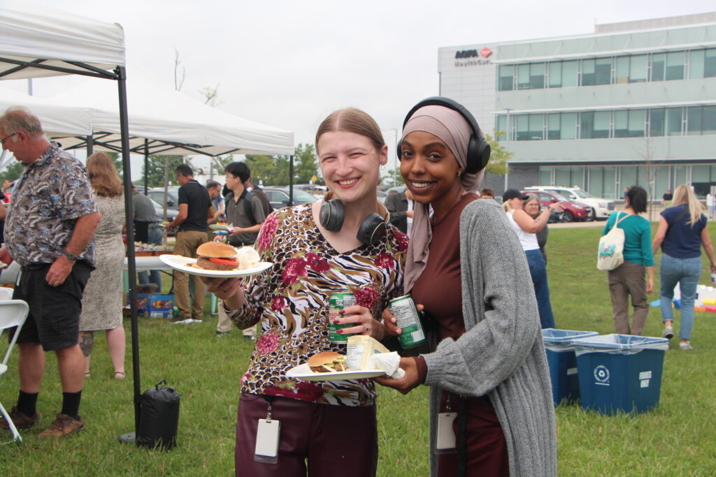Two co-op students from EY at The Cora Group's Tenant Appreciation BBQ